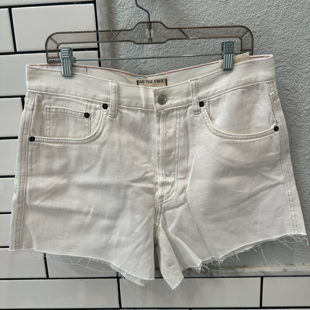 Free people we the free IVY raw hem mid rise denim shorts in Crystal clear